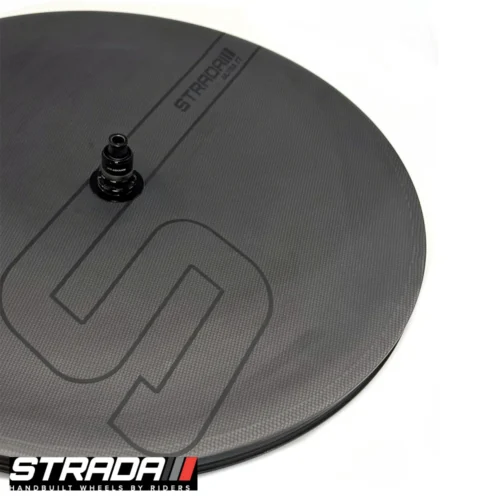 A picture showing a carbon Strada Ultra TT Disc disc Brake rear wheel in a raw carbon finish with a custom Strada S shape logo in Black