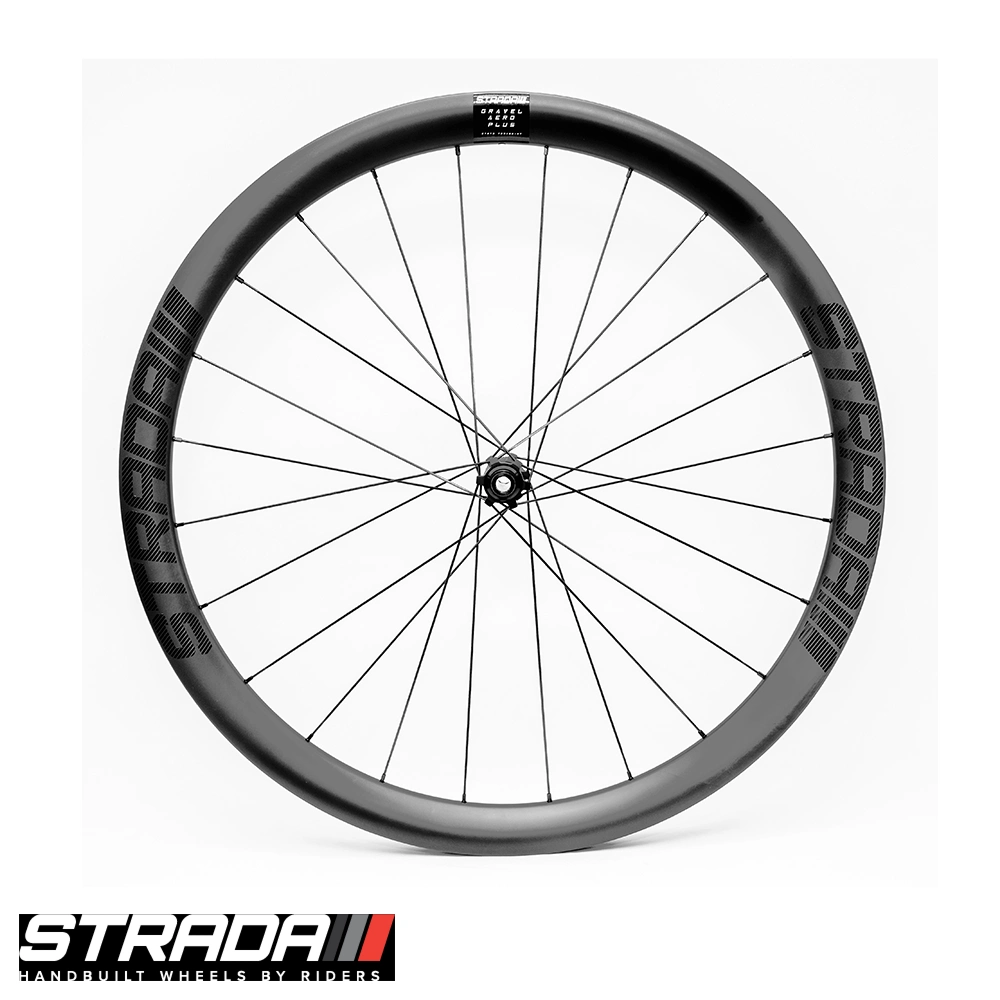 Front-facing profile of Strada Gravel Aero Plus carbon front wheel with deep-section rim, Strada logo and black spokes on white background